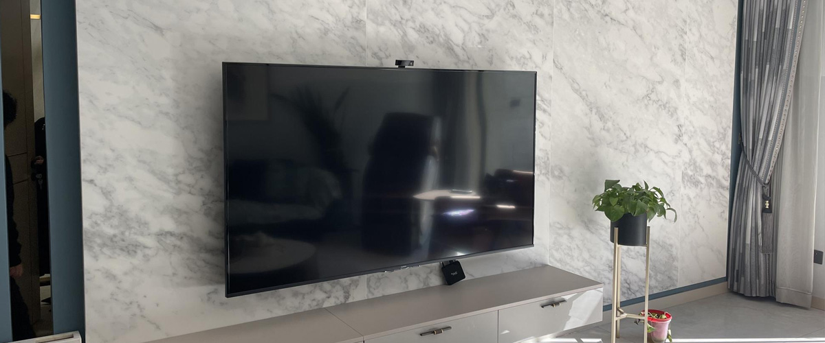 Mounted TV on a concrete wall in a modern living room
