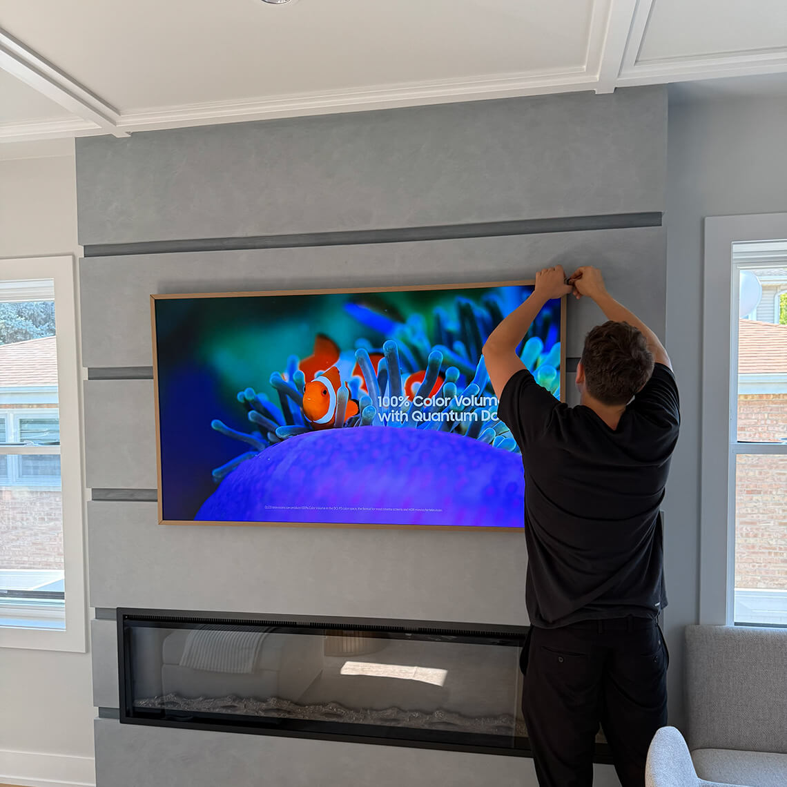 TV being mounted on a brick fireplace wall in a Chicago home