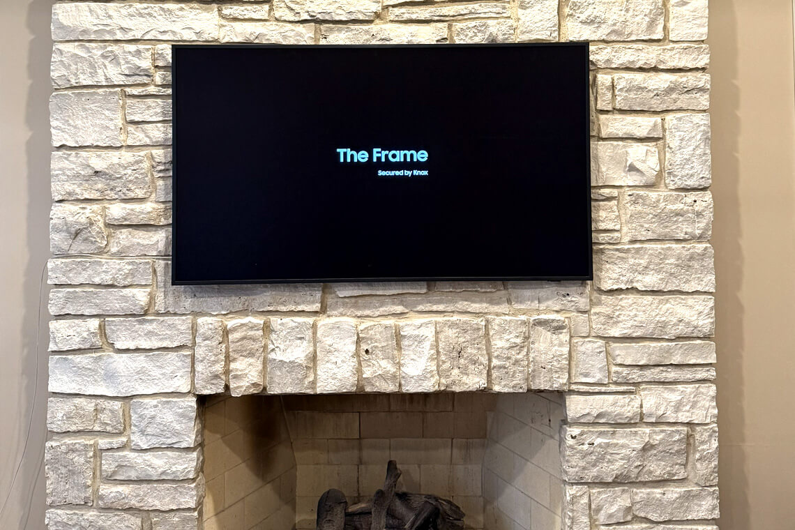 TV installed over a stone fireplace in a Chicago home